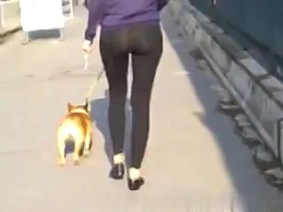 girl in leggings on a walk with a pet